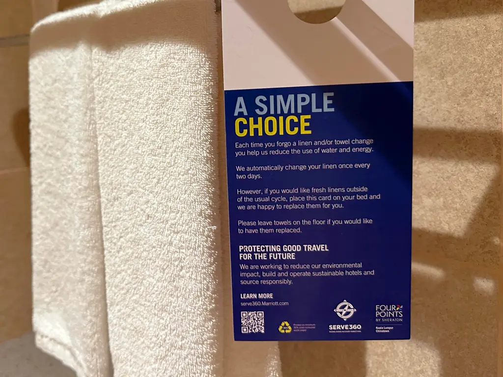 Placard on towel rack highlighting Marriott International's Serve 360 sustainability initiative, Four Points by Sheraton Kuala Lumpur, Chinatown