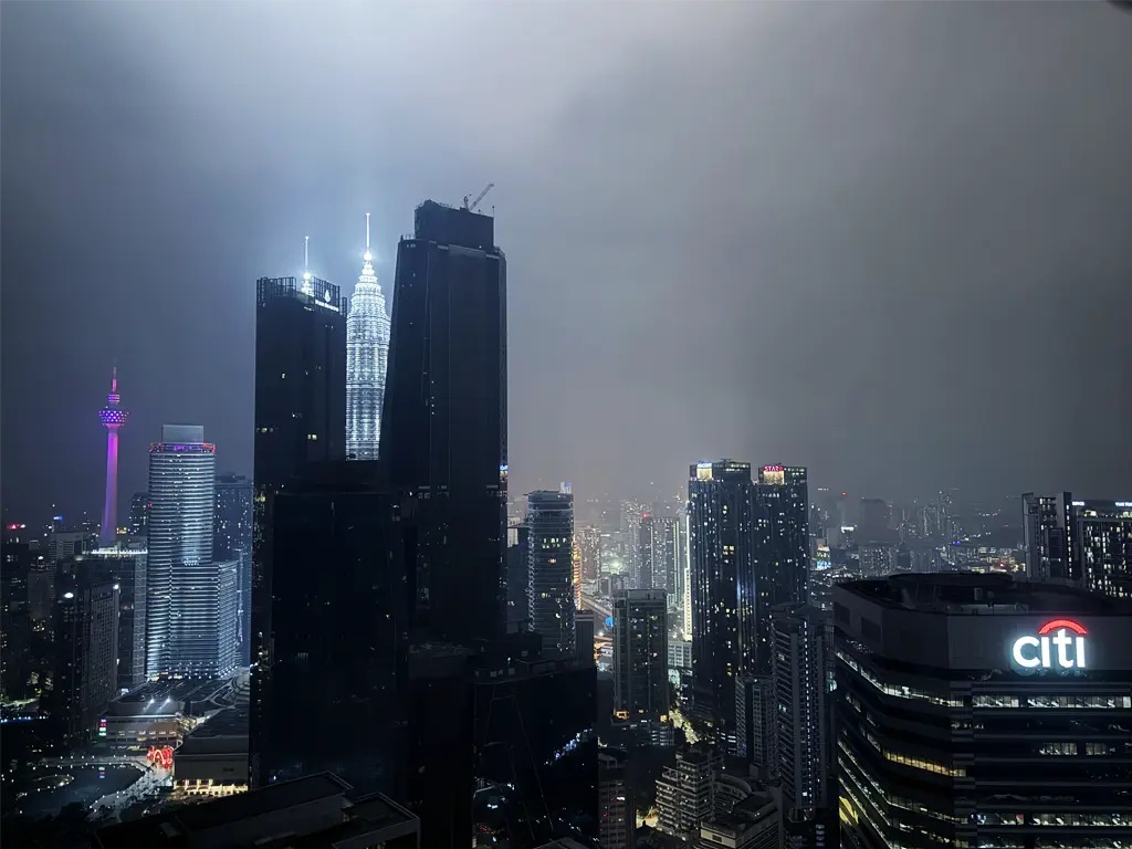 Petronas Twin Towers illuminating the night sky, viewed from Element Kuala Lumpur's suite window